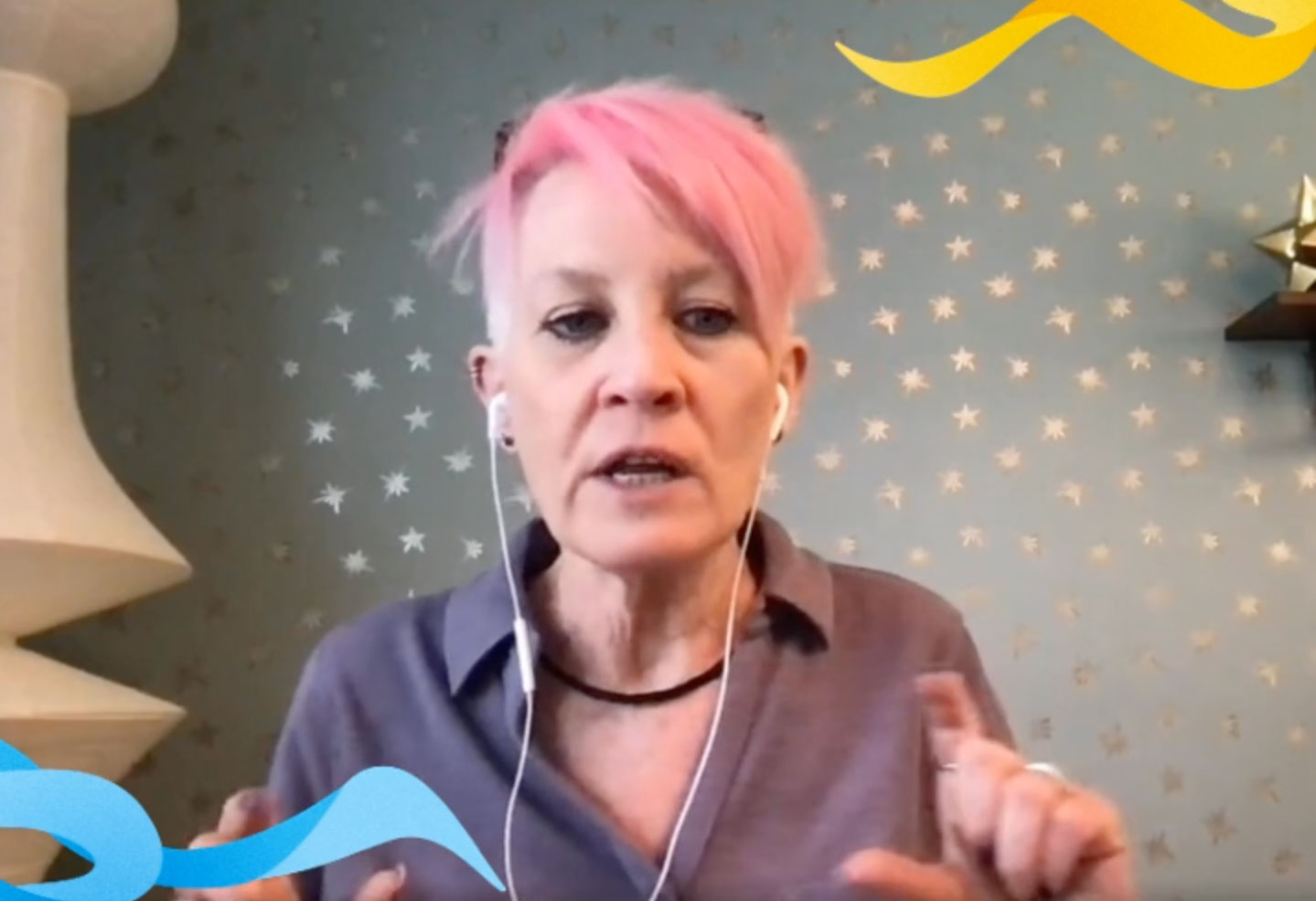 Woman with pink hair (Susan Lambert) hosting a podcast on the Science of Reading